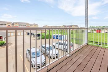 A parking lot with cars and apartment buildings in the background.